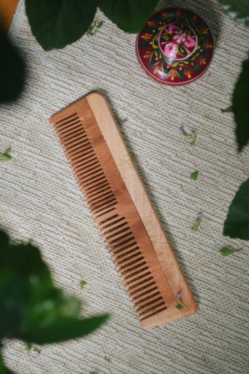 Dual tooth neem wood comb by Almitra Sustainable with fine and wide teeth designed for gentle detangling and sustainable plastic-free hair care.