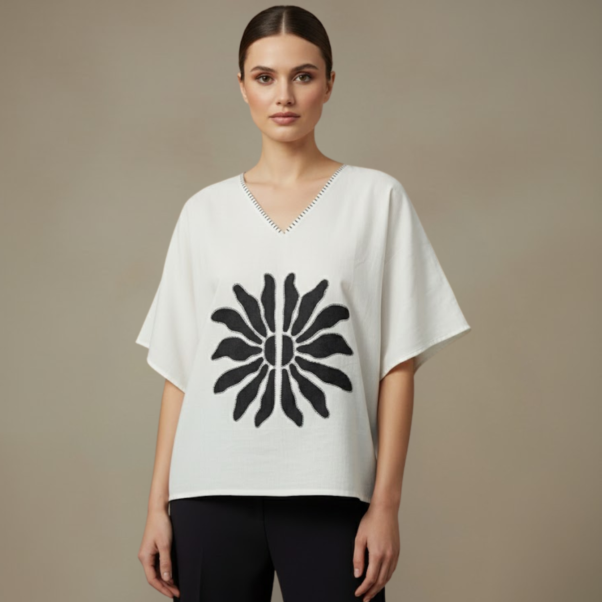 Woman wearing a Mangalagiri Cotton Anti-Fit white top with a black floral design on a beige background