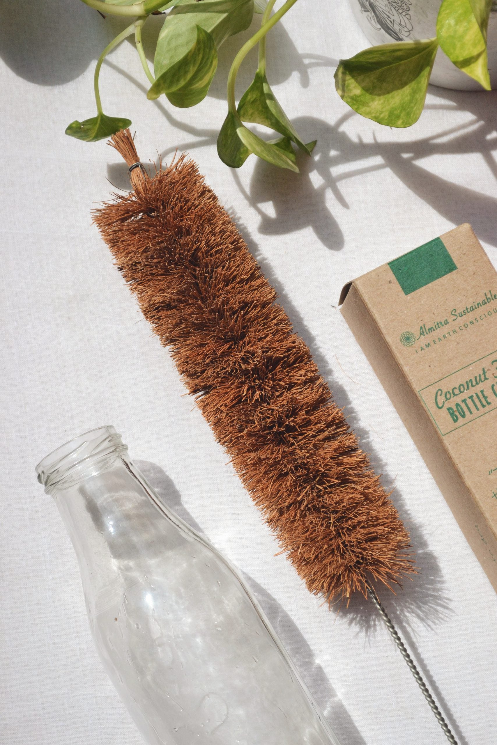 Eco-friendly bottle cleaner with slender coconut bristles and a wooden handle for reusable bottle hygiene.