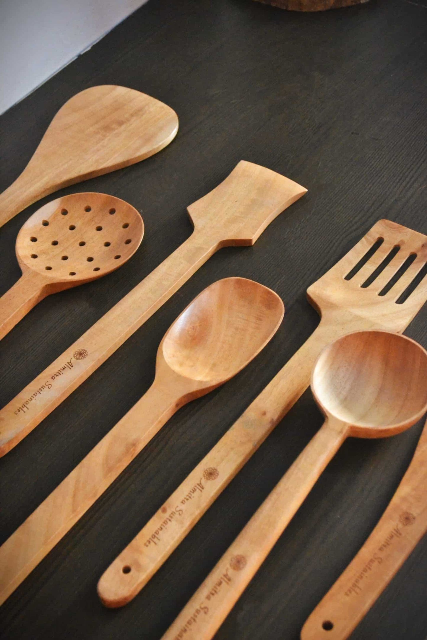 Angled view of a natural neem wood ladle set by Almitra Sustainables, highlighting the ergonomic design and warm wood tones, ideal for eco-conscious cooking routines and plastic-free kitchens.

