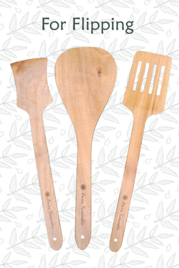 Neem wood flipping spatulas by Almitra Sustainables displayed on patterned background, handcrafted wooden kitchen utensils ideal for flipping, sautéing and cooking while protecting non-stick cookware.