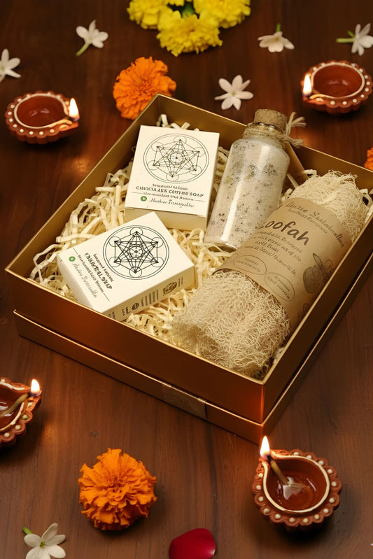 Eco-friendly self-care gift hamper by Almitra Sustainables featuring a natural loofah, two handmade herbal soaps, a glass jar of bath salt, and a coconut shell soy wax candle, all packed in a sustainable kraft gift box with shredded paper filler. Ideal for zero-waste festive gifting or wellness hampers.